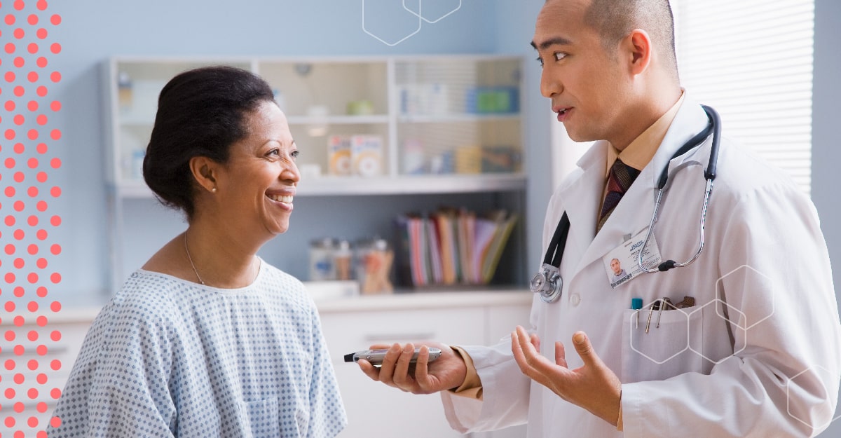 A woman speaks with her doctor in the doctor's office.