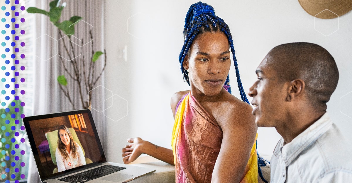 An LGBTQ+ couple speaks with a doctor via computer.