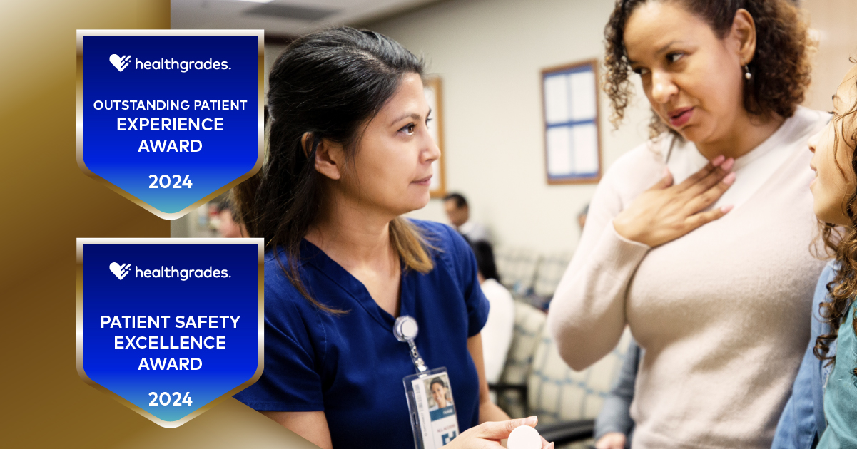 A young clinician converses with a woman and her daughter in a waiting room.