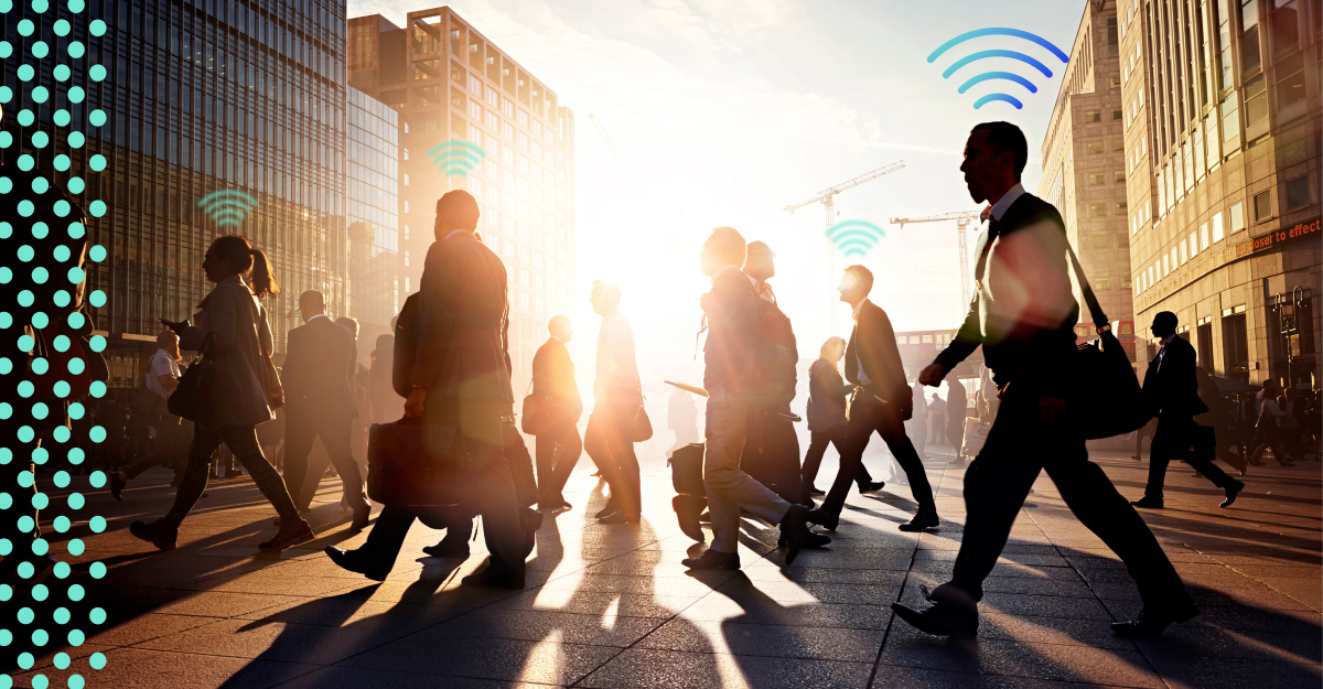 A group of pedestrians cross a sidewalk with the sun shining in the background